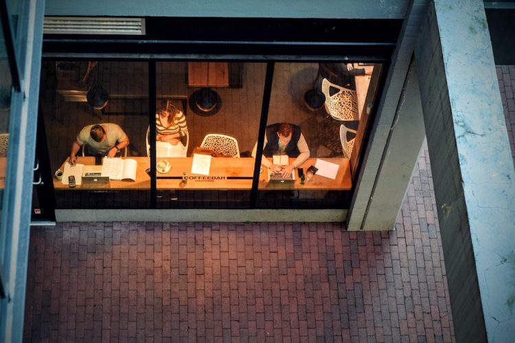 Group of people sit at a desk working after hours