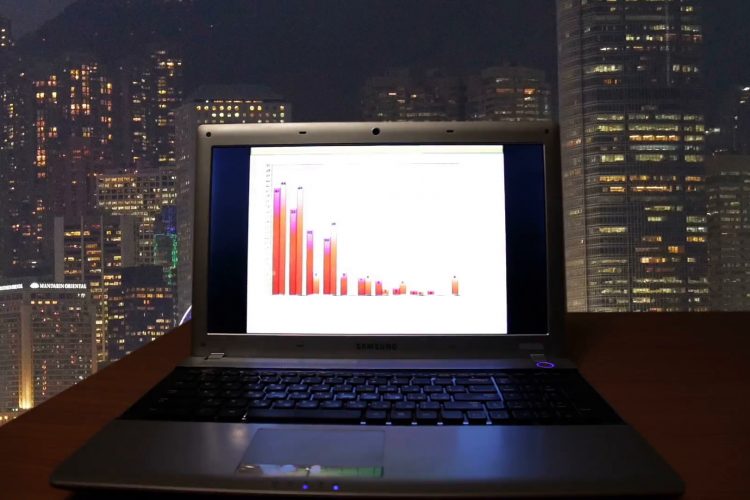 Laptop computer sitting on desk in dark room