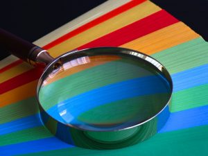 Magnifying glass on colored paper