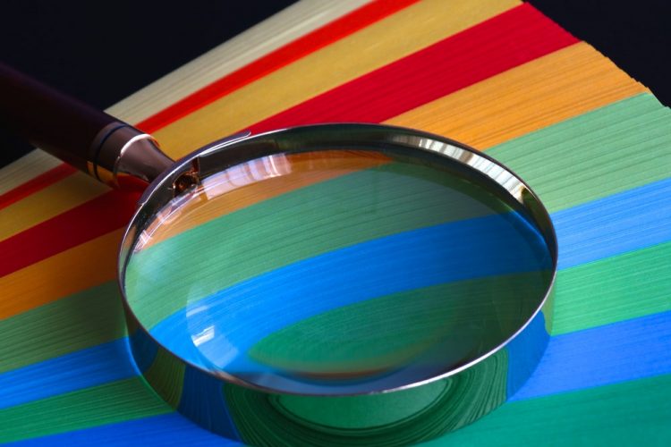 Magnifying glass on colored paper