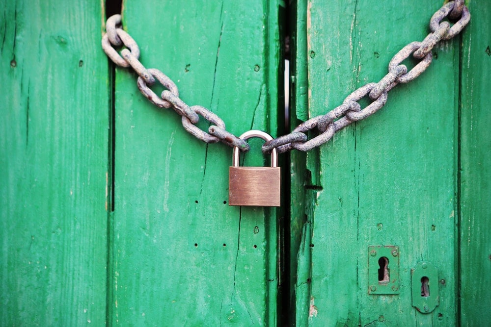 Padlock on a green door